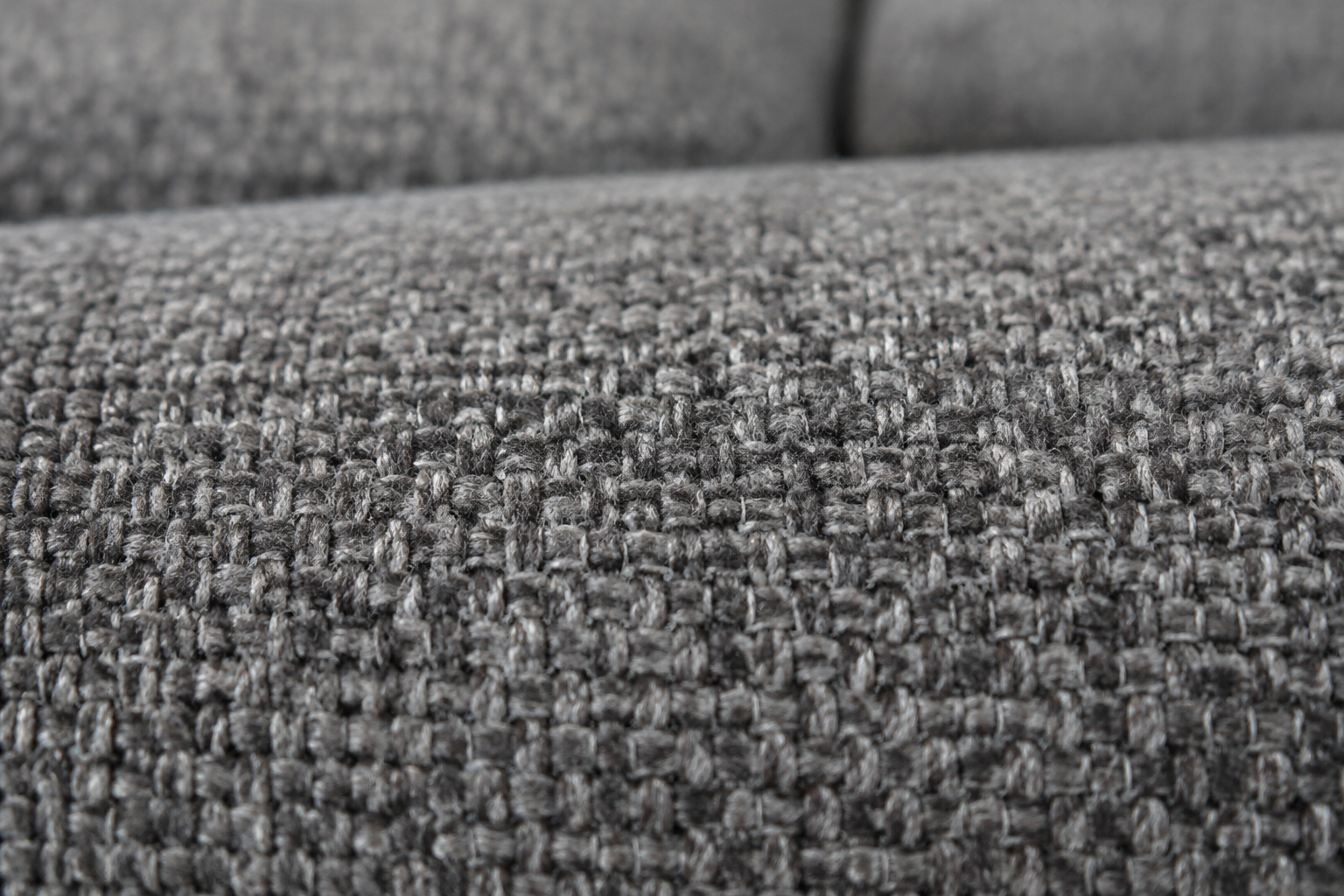 Gros plan sur la texture tissée serrée du tissu microfibre d'un canapé